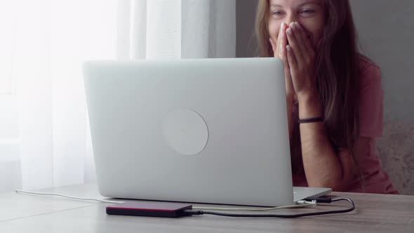 Woman behind laptop at home