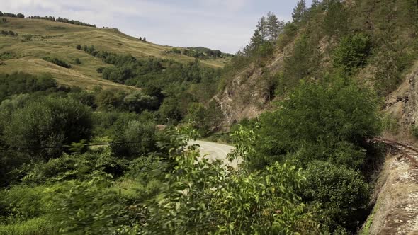 Mountain Pass And Rugged Terrain With Lush Green Forest In Maramures, Romania. wide shot alt