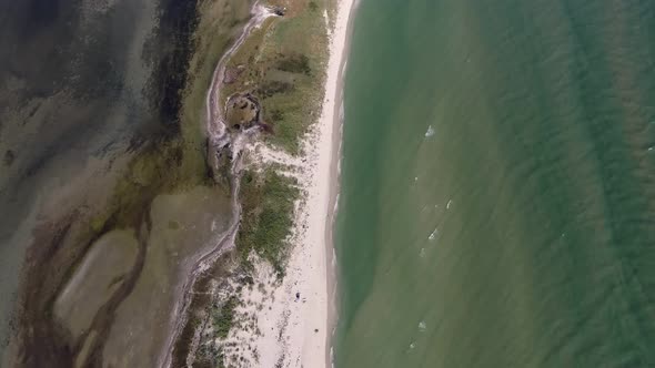 Aerial Shot of a Picturesque Limestone Sandspit on the Black Sea in Summer. alt