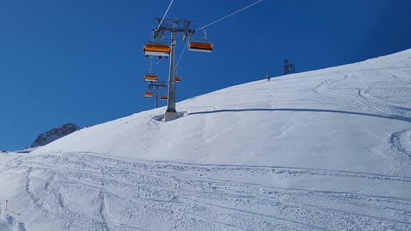 Ski lift in a ski resort in the german alps. Skiers on a ski slope on a sunny winter day.