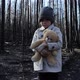 Little girl with teddy bear in burnt forest - VideoHive Item for Sale