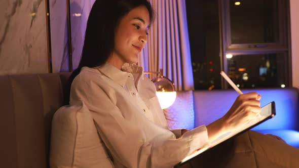 Young Asian beautiful woman enjoy using smartphone- tablet alt