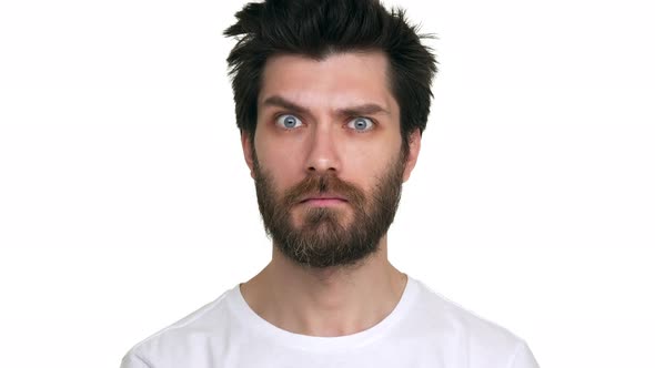 Bearded Man Moving Eyebrows Looking Straight Confident Playful on White Background alt