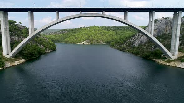 Aerial view of famous bridge over Krka river in Croatia, Europe. Drone flying under the bridge