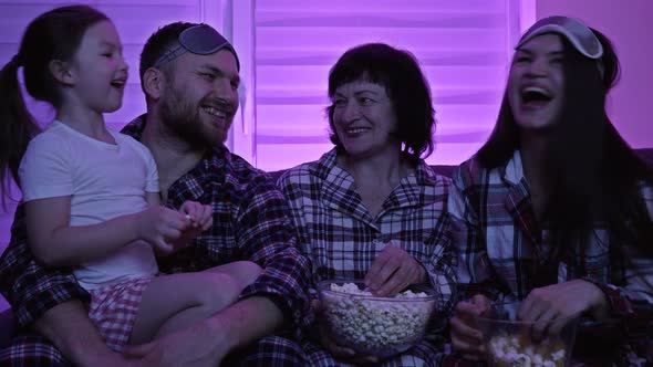 Friendly Family of Four Watches TV and Eats Popcorn alt