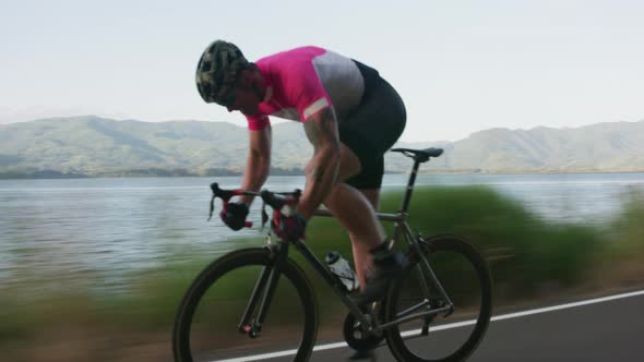 Tracking shot of a male cyclist on country road.  Fully released for commercial use.