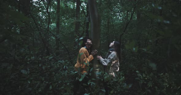 Man and Woman hug tree in forest alt