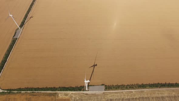 Wind Vane Green Energy Against the Yellow Plains, Aerial Survey alt