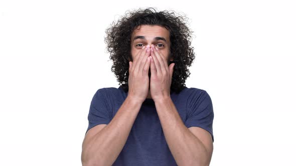 Portrait of Wellbuilt Football Player with Curly Hair in Casual Dark Blue Tshirt Covering Face in alt