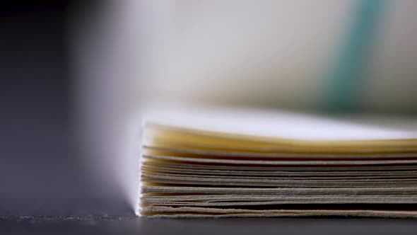 Flipping Blurry Pages of a Book in the Studio on a Black Background alt