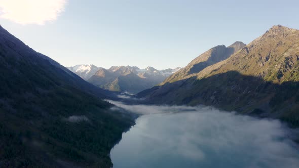 Slow flight Multinskoe Lake in the Altai Mountains in Cloudy Morning