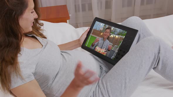 Mom Communicates with Her Son on His Birthday. Cake with Candles Shown in Webcam. Home Quarantine alt