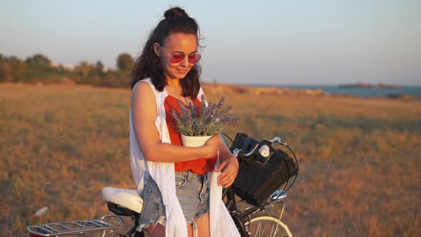 Portrait of Satisfied Beautiful Young Woman with Bouquet of Flowers Smiling Looking Away Standing on alt