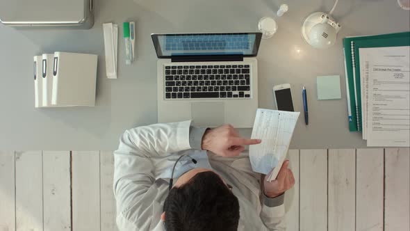 Top View of Doctor Videochatting Online With Patient On Laptop alt