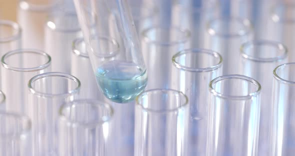 Chemist doing science experiment with chemicals alt