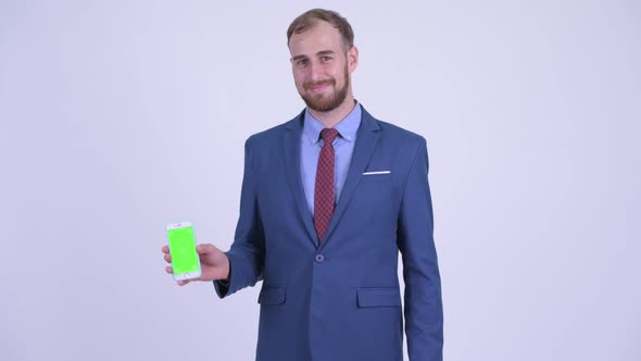 Happy Bearded Businessman Showing Phone and Giving Thumbs Up