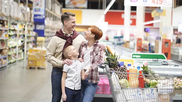 Caucasian Family Buying Healthy Food Products in Grocery Store Posing at Camera