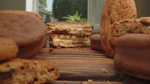 Macro Zoom in Video of Crispy Oat Cookies on Wooden Board in Kitchen
