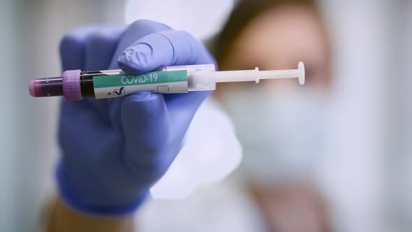 Doctor showing positive medical result of coronavirus. Shot with RED helium camera alt