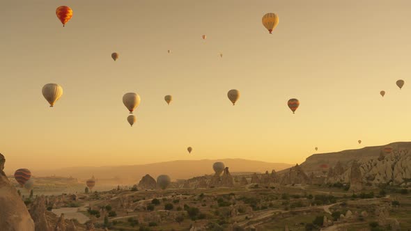 Many Hot Air Balloons Flying Over Love Valley Early in Morning in Cappadocia