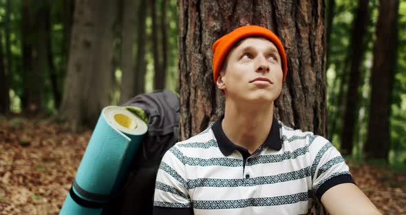 Man Relaxing in Forest Near Tree