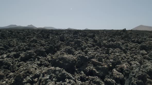 Volcanic rocky soil of Timanfaya National Park alt