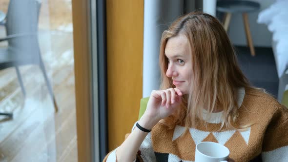 portrait of charming blonde woman in scandinavian interior