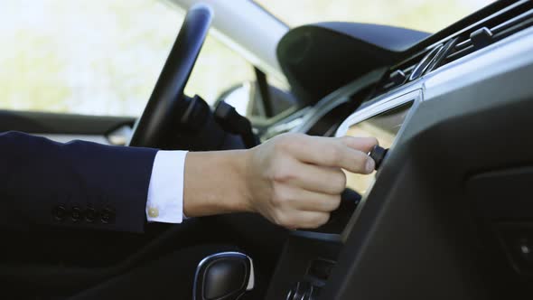 Unrecognizable Male Man Hand Touching Swiping on Screen Monitor on Modern Luxury Car alt