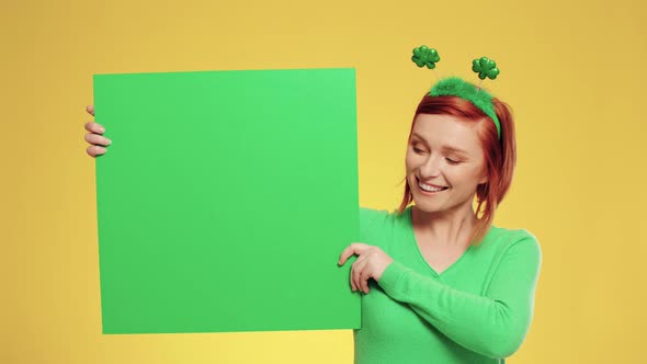 Portrait of woman holding green banner with copy space alt