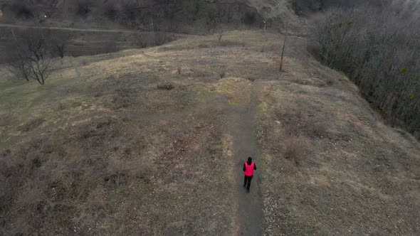 Aerial view drone Athletic man in red west running in the nature alt
