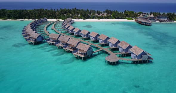 Wide aerial island view of a paradise sunny white sand beach and aqua blue water background in colou alt