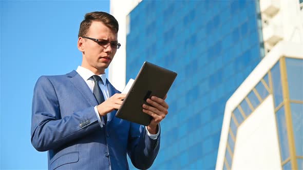 Businessman Talking On Phone With Tablet