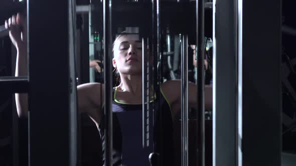 Attractive Woman in the Gym Doing Pulldown Exercises To Front in Silhouette alt