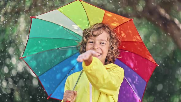 Happy Child Playing in the Rain