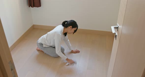 Woman clean the floor at home alt
