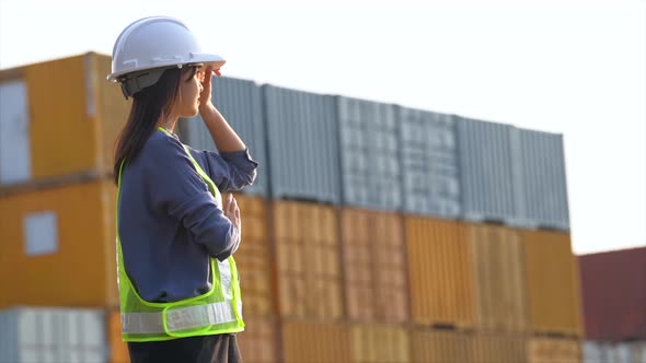 Worker woman checking and control loading containers box from cargo