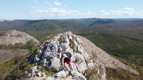 Man hiking in mountains with backpack, enjoying his adventure tourism concept. alt