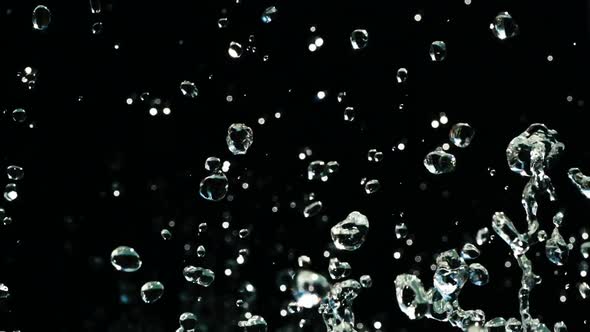 Water Droplets Rise in the Air Against Black Background. Slow Motion Water  Splash on Black by jm_video