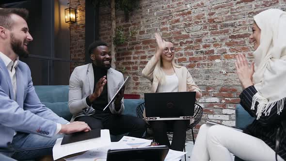 Different Ethnicity Business Team of Women and Men which Giving High Five alt