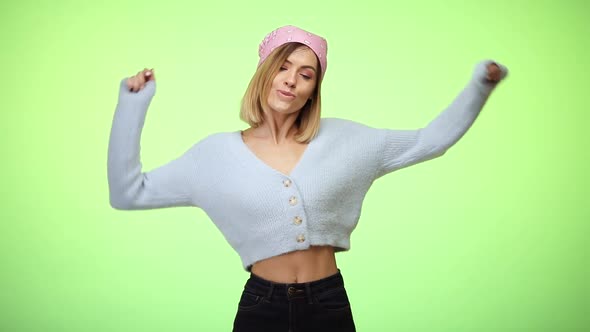 Woman in Blue Sweater and Pink Scarf Dancing