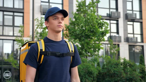 Delivery Man Courier with Thermal Bag Walks Street Deliver Online Order Client alt