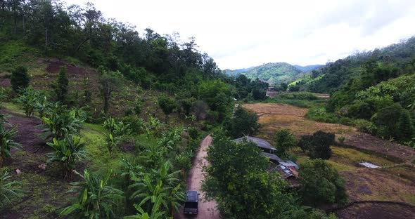 a group walking along a dirt road preparing for a jungle trek. alt