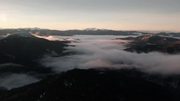 Aerial View of Mountain Valley With Sea of Clouds at Sunrise