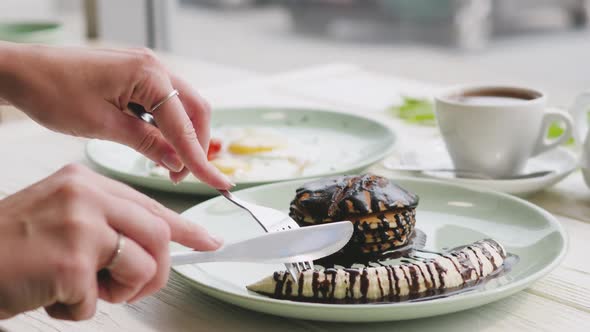 Delicious and Healthy Breakfast. Breakfast of Fried Eggs, Dessert and Tea. Pancakes with Chocolate alt