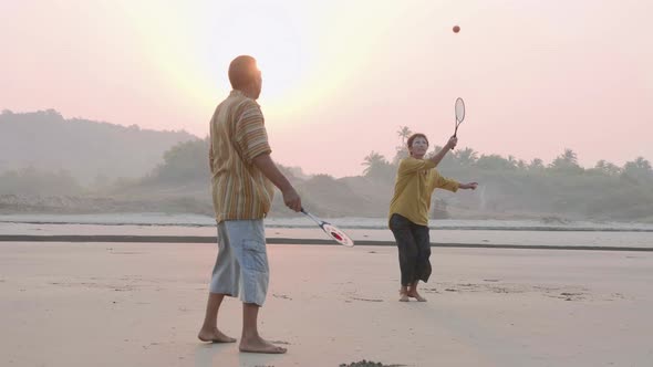 Active Senior Couple Playing Tai Chi Ballon Ball at the Beach