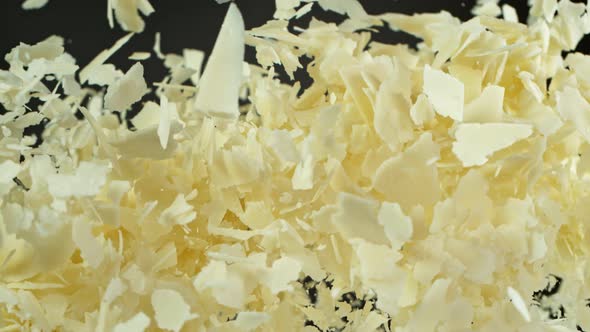 Super Slow Motion Shot of Flying Parmesan Shavings on Black Background at 1000 Fps alt