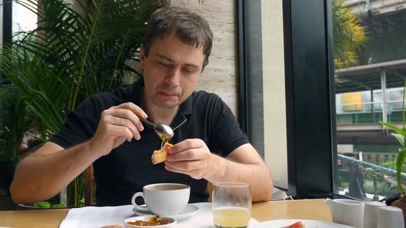 Male Enjoy Eating Morning Food in Restaurant Drinking Hot Cappuccino Coffee alt