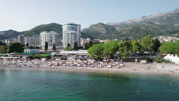 Aerial View Budva Beach By Sea with Sun Loungers and People Seashore Montenegro alt