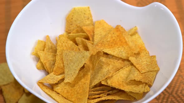 Falling nachos in a slow rotating bowl