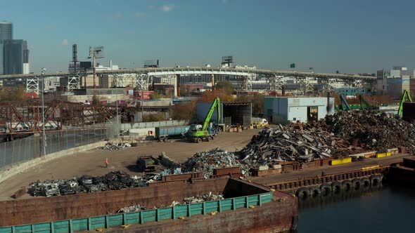 Slide and Pan Footage of Loader Moving on Scrap Yard on Newtown Creek Waterfront alt